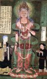 This painting of Avalokitesvara or Guanyin was donated to the Mogao Caves in 910 CE by a reverend nun named Yanhui 'on behalf of my elder sister and teacher and on the souls of my dead parents that they me born anew in Pure Land'. Yanhui stands on the right hand side of Avalokitesvara, her younger brother on the left.