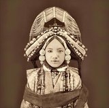 An early photograph by Sarat Chandra Das of a Tibetan priness (lhacham) wearing traditional clothing, heavy jewellery and a very elaborate headdress.